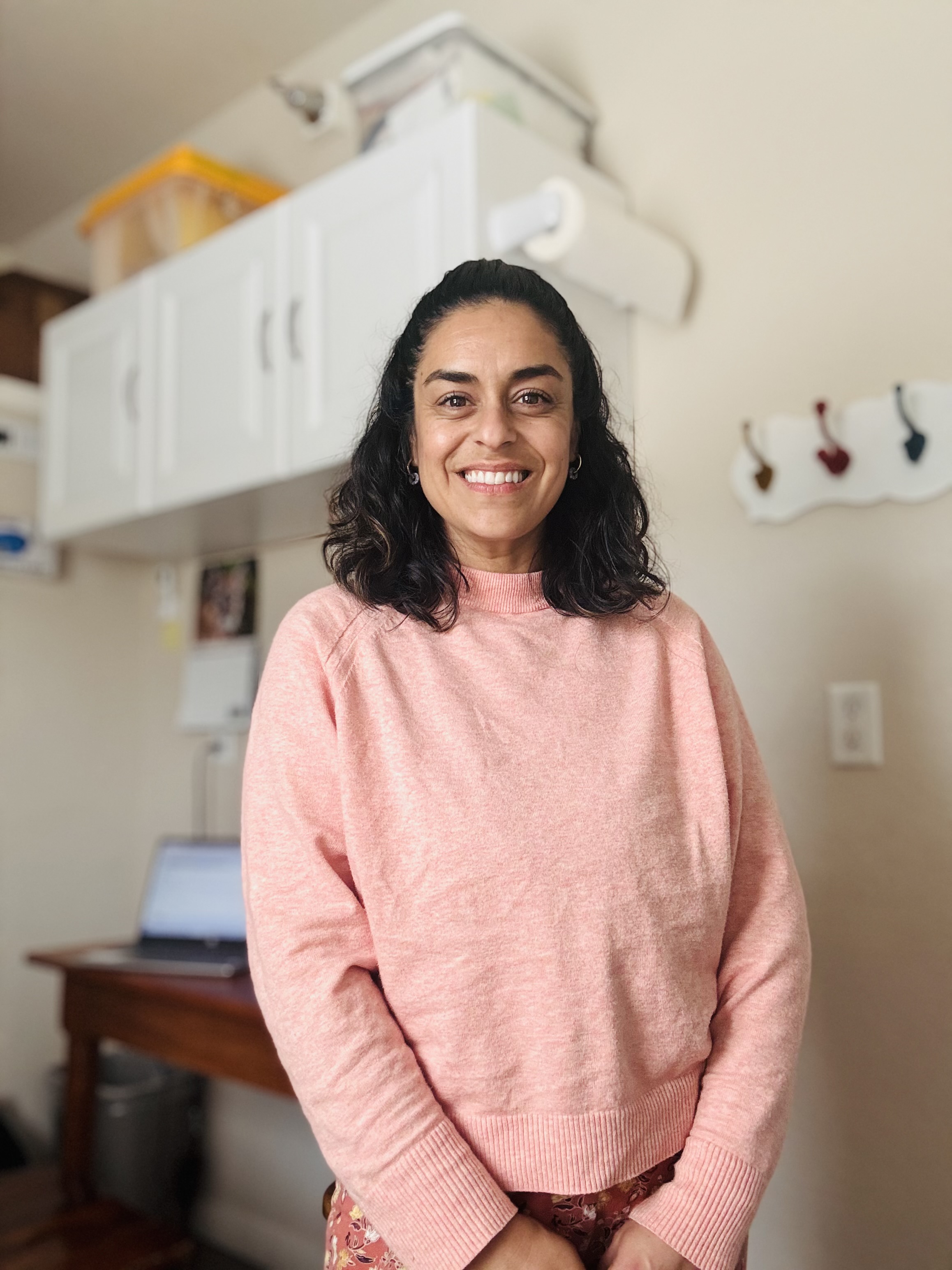 Portrait of Laura Allred, MS, CCC-SLP, smiling in a calm, light-filled space.